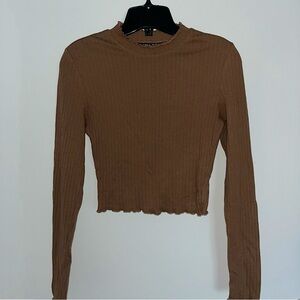 Long-sleeved brown top with details on the collar and sleeves
